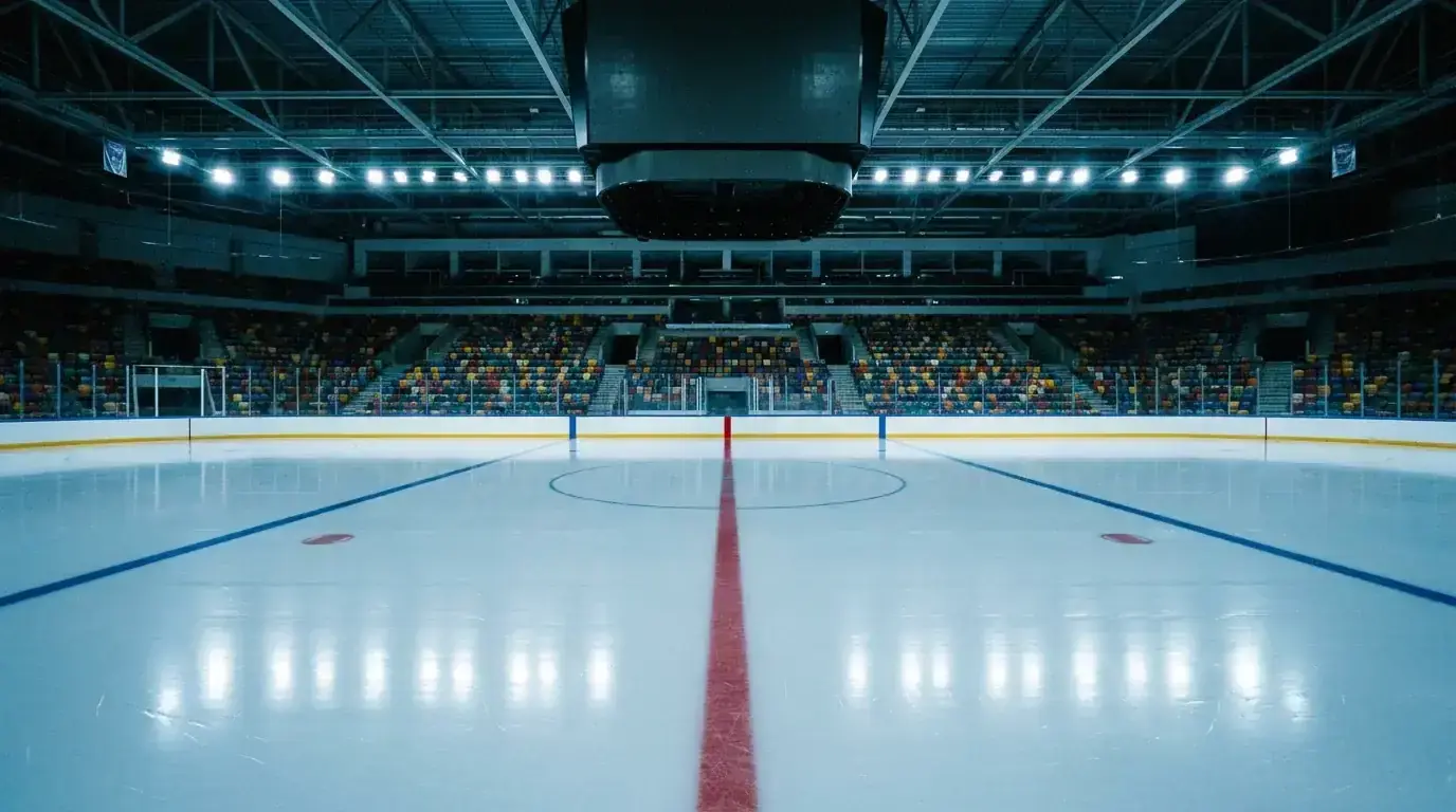 Empty ice hockey rink with overhead scoreboard and fresh ice surface ready for the next game