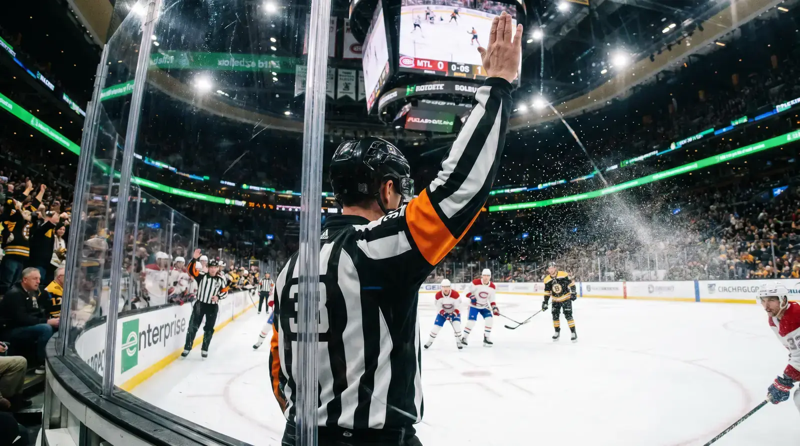 NHL referee making a penalty call during a game