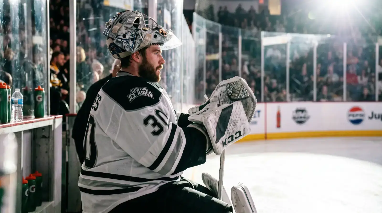 NHL goaltender adjusting equipment before a game